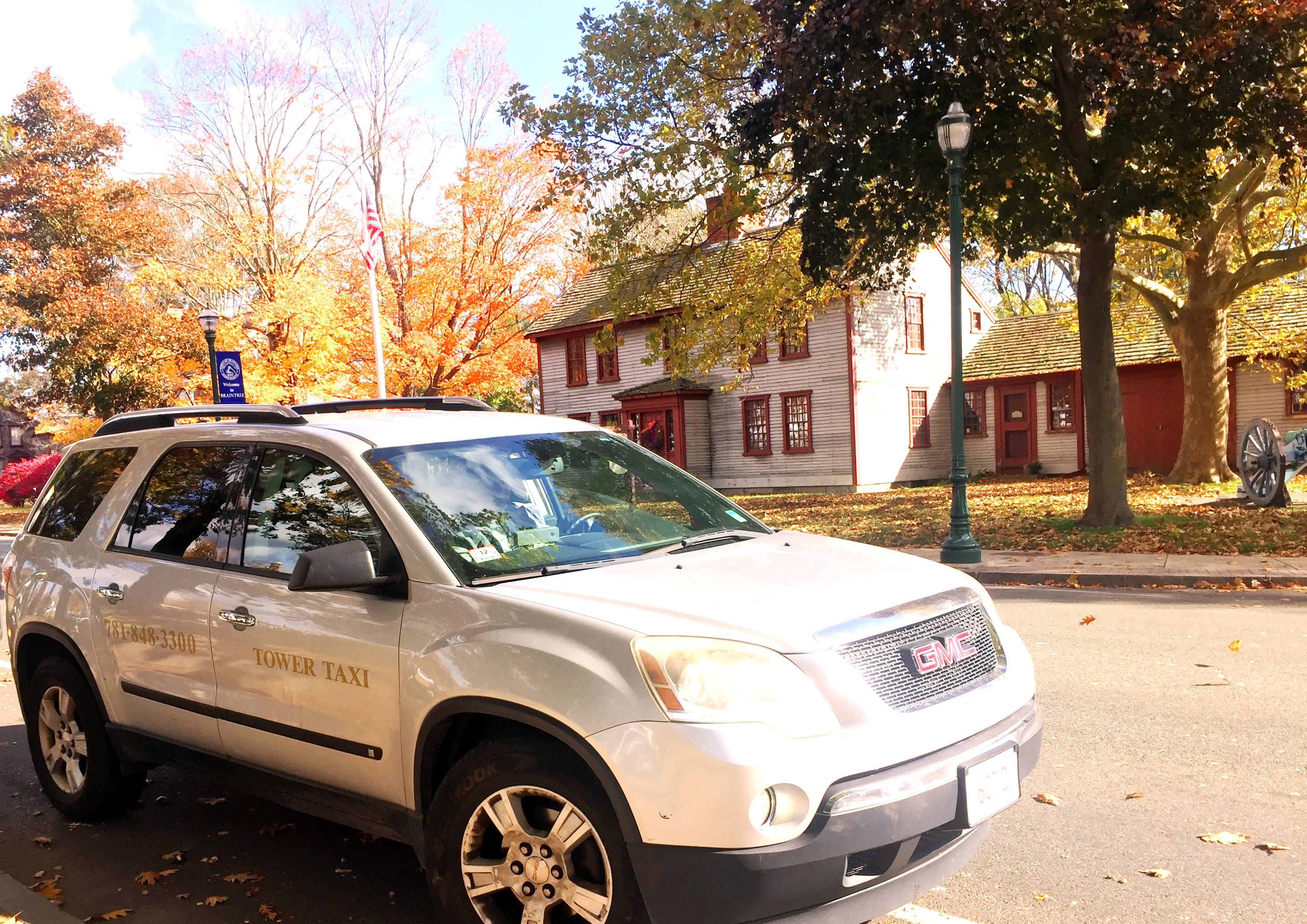 Tower Taxi vehicle in front of a historic Braintree building
